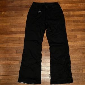 Marker woman’s black ski pants with aqua guard stretch.